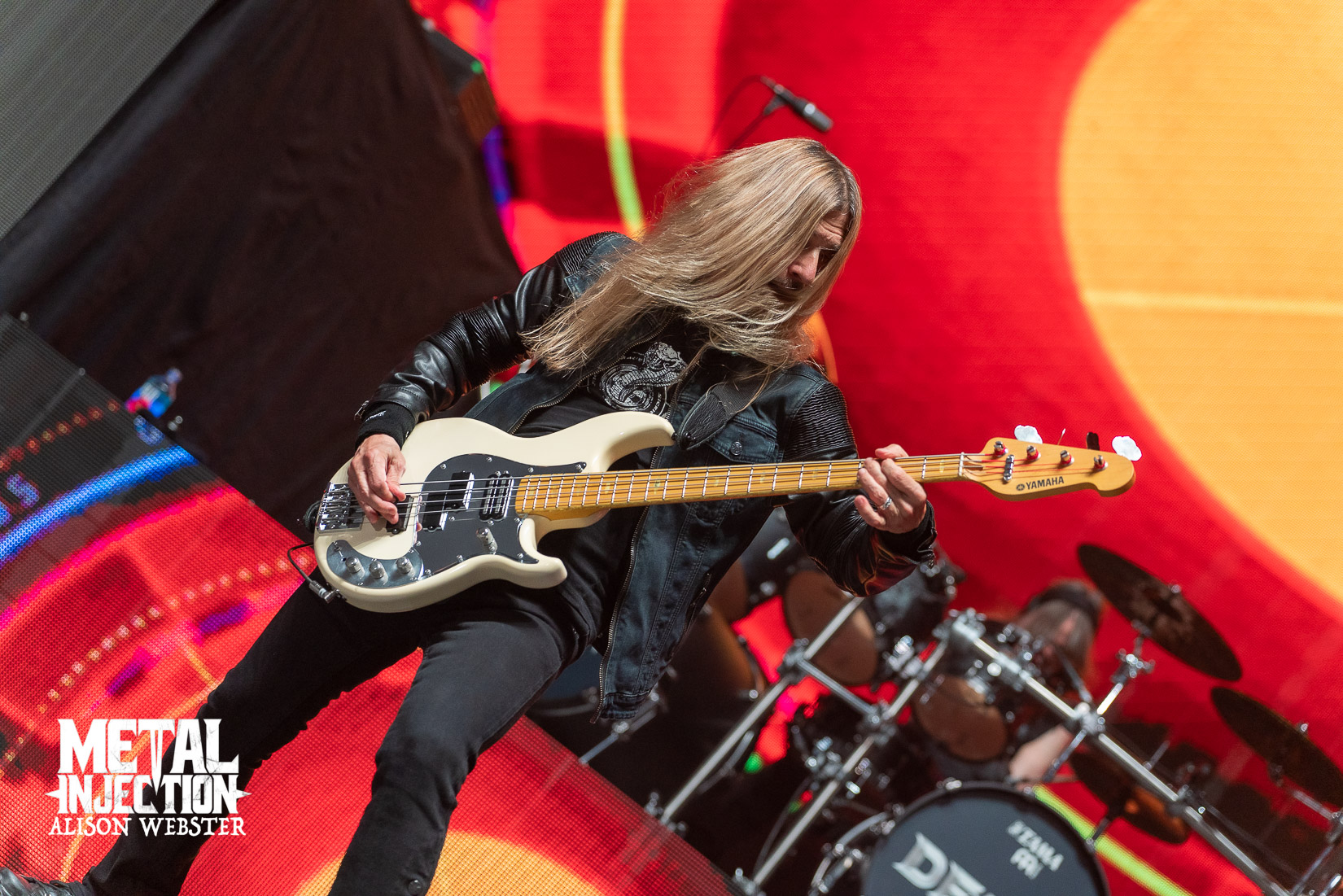 James LoMenzo playing bass on stage during a live Megadeth concert performance.