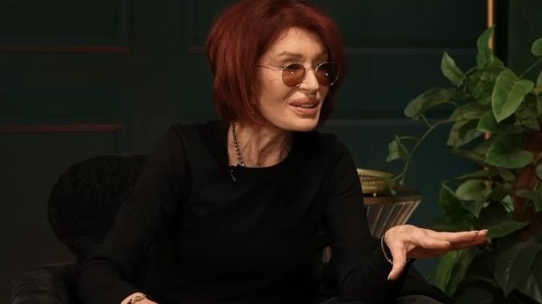 Sharon Osbourne speaking into a microphone during a recording session of The Osbournes podcast in a studio setting.
