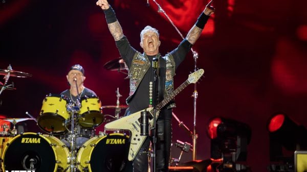 A photo of James Hetfield and Lars Ulrich performing with Metallica live on stage.