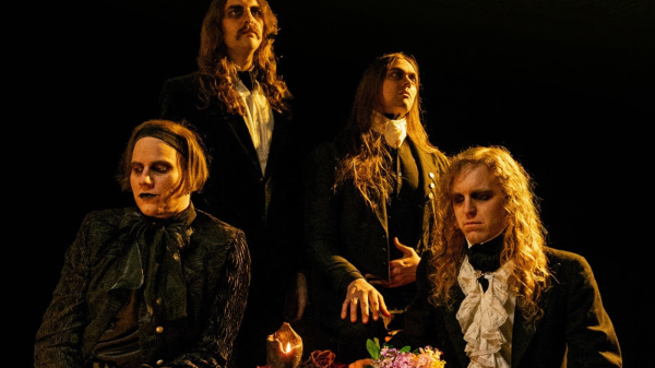 Promotional photo of the band Spell, featuring Cam Mesmer (vocals, bass, rhythm guitar, synthesizers), Al Lester (vocals, lead guitar, rhythm guitar, drums), Jeff Black (lead guitar, backing vocals), and Gabriel Tenebrae (lead guitar, synthesizers).